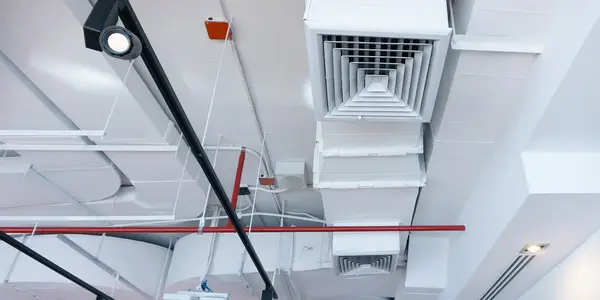 Ceiling view of HVAC ductwork and ventilation systems.